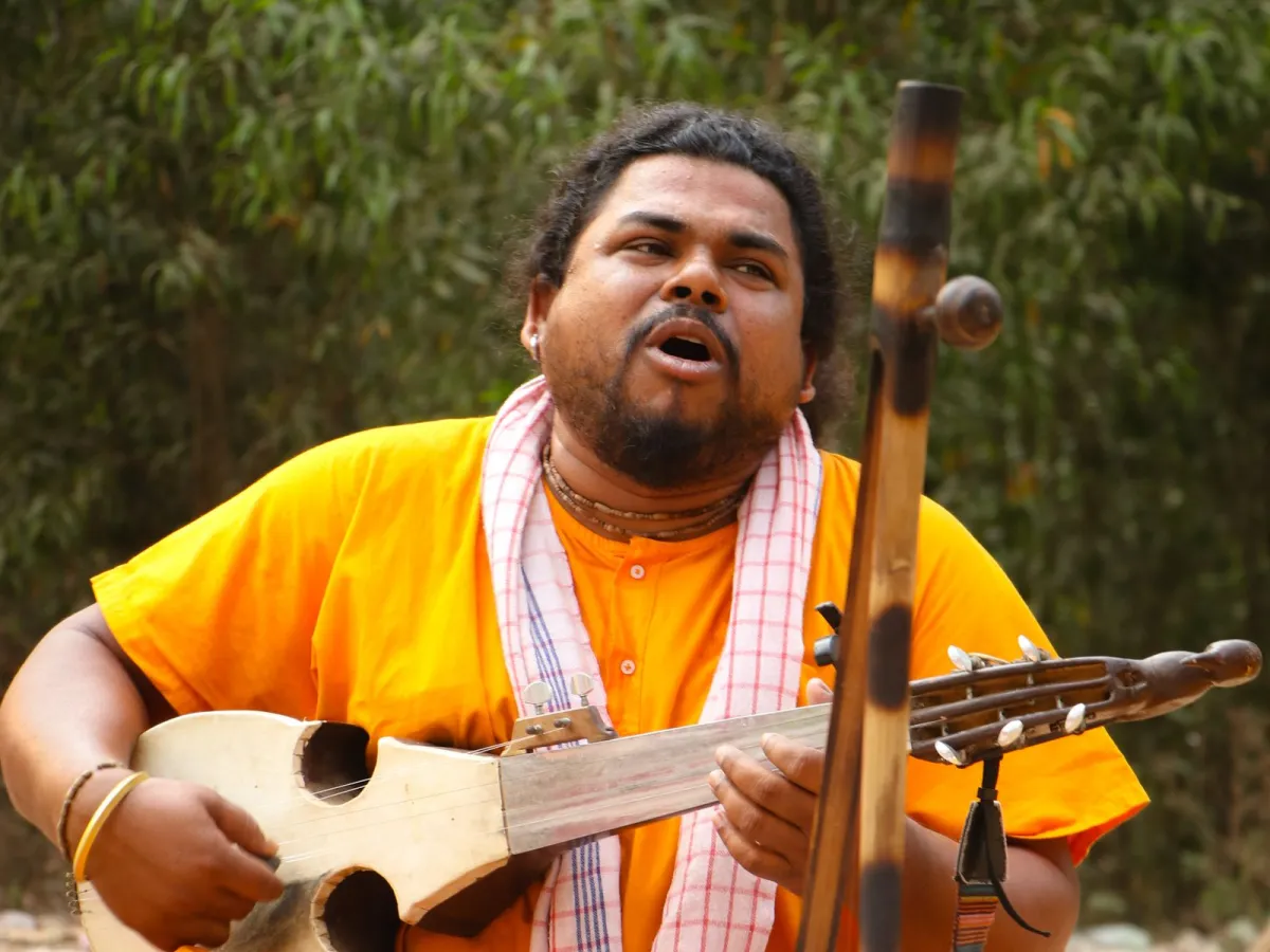 A Baul folk singer of Bengal performing a ballad on the dotara, mid-verse